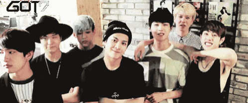 a group of young men are posing for a picture with the word got7 on the bottom right