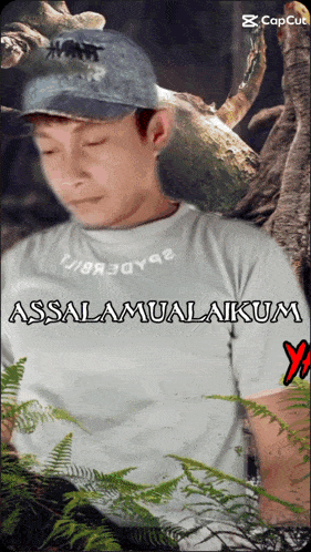 a man wearing a white shirt that says assalaamualaikum