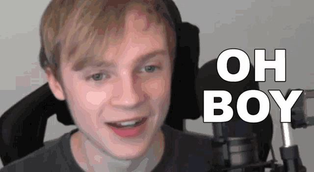 a young man sitting in front of a microphone with the words oh boy above his head