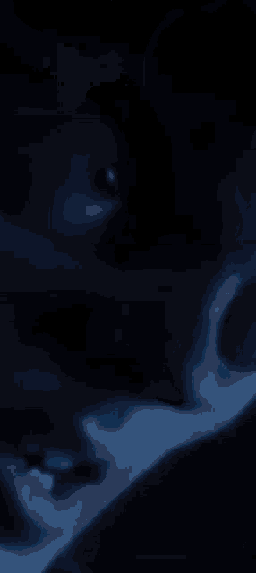 a close up of a person 's eye in the dark