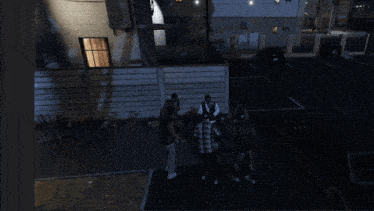 a group of people are standing in front of a building with a car parked in front of it