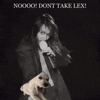 a woman in a suit is holding a puppy in her arms with the words noooo dont take lex written above her