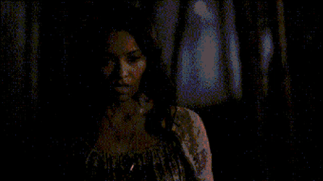 a blurry picture of a person holding a candle