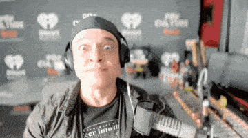 a man wearing headphones and a t-shirt that says " enter into the unknown "