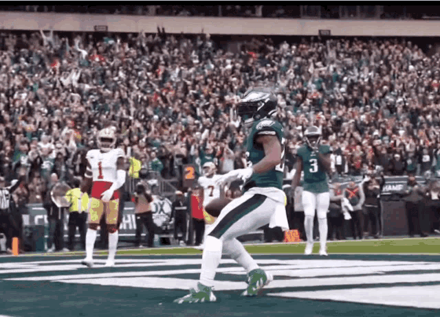 a football player in a green jersey with the number 3 on the back