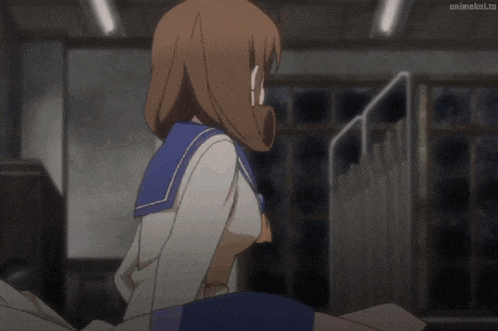 a girl in a sailor uniform is sitting on a person 's back