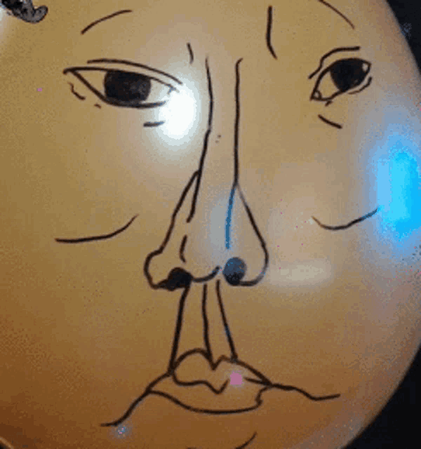 a drawing of a face on a balloon with a blue light behind it