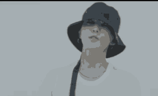 a man wearing a black hat and a white shirt