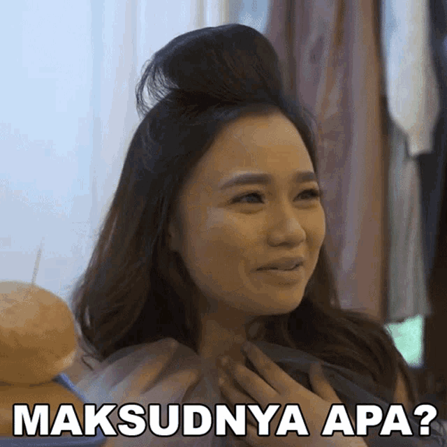 a woman with her hair in a bun says maksudnya apa?