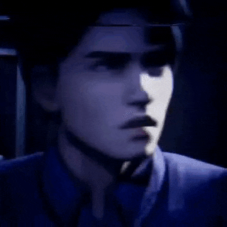 a man in a suit and tie is looking at the camera with a blurred image of his face behind him .