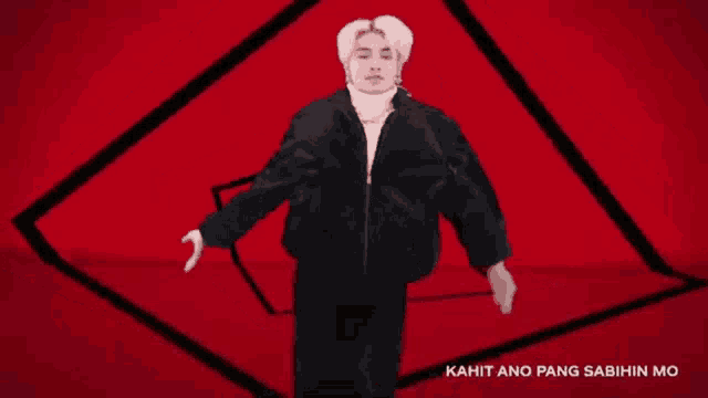 a man is dancing in front of a red background and the words kahit ano pang sabihin mo