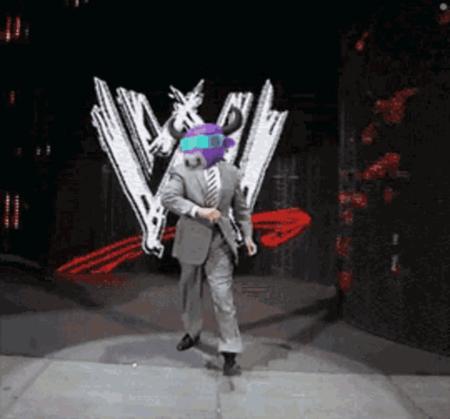 a man in a suit and tie is dancing on a stage in front of a w logo