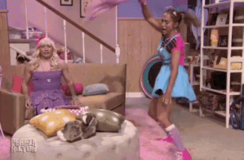 a woman in a blue dress is dancing in a living room