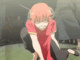 a girl with red hair is kneeling down with a sword in her hand