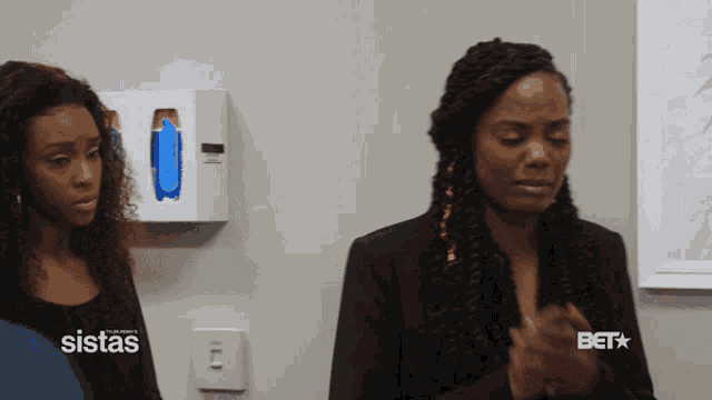 two women standing next to each other with the word sistas on the bottom