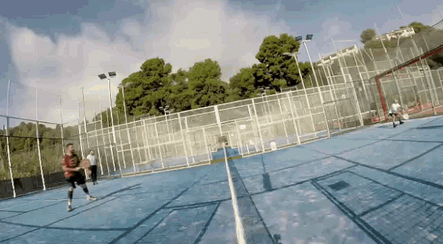 a group of people are playing basketball on a court