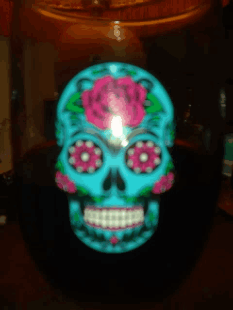 a day of the dead sugar skull with pink roses