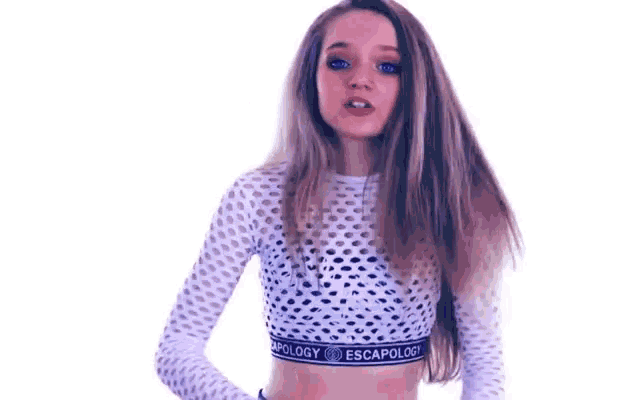 a young girl is wearing a crop top and a crop top with a mesh top .