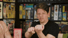 a man is holding a ring in front of a book titled would you still love me if