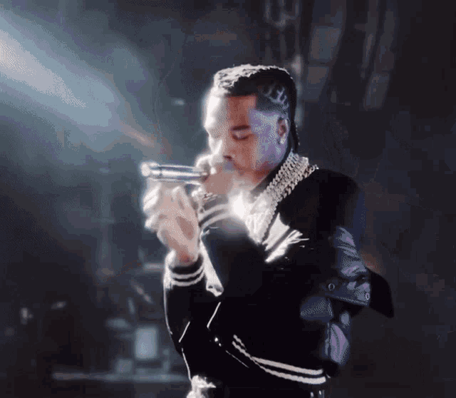a man in a black and white jacket holds a gun