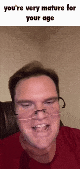 a man wearing glasses and a red shirt with the words you 're very mature for your age
