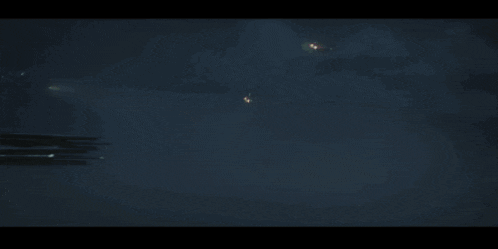 a space ship is flying through the air in a dark room