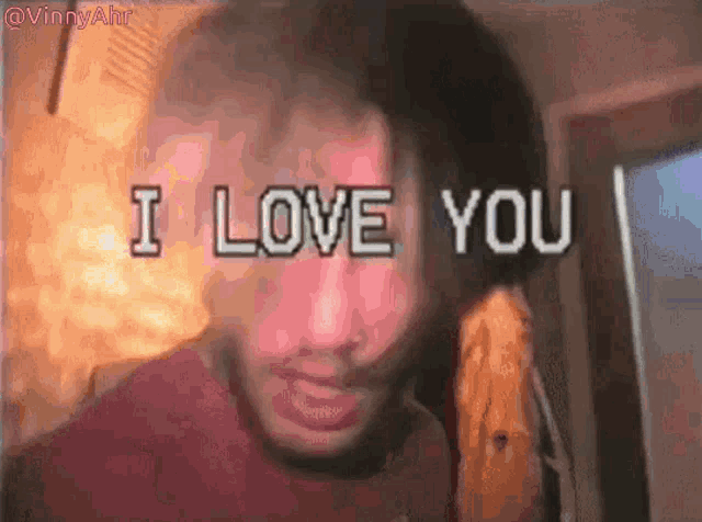 a man is standing in front of a sign that says `` i love you ''