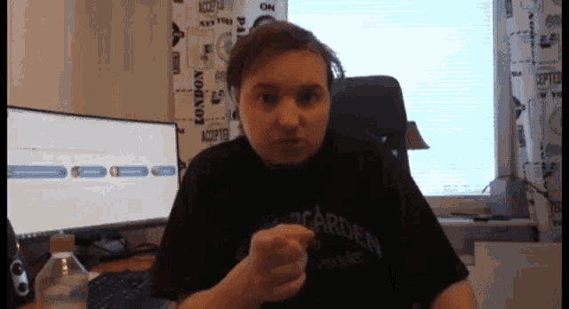 a man wearing a black shirt that says ' bacardi ' on it