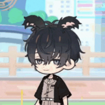 a boy with bunny ears on his head is standing in front of a fence .