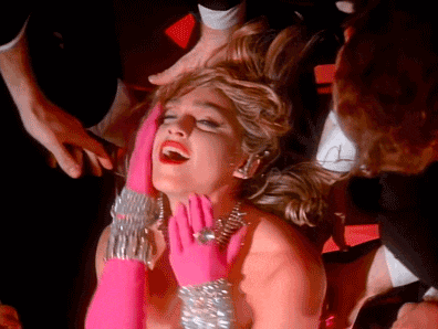 a woman wearing pink gloves and silver bracelets is being touched by a man