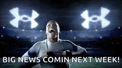 a man is screaming in front of a stadium with the words `` big news comin next week '' written on the bottom .