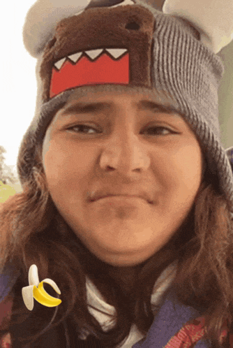 a girl wearing a beanie with a shark on it