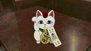 a woman and a girl are standing next to a table with a white cat on it .