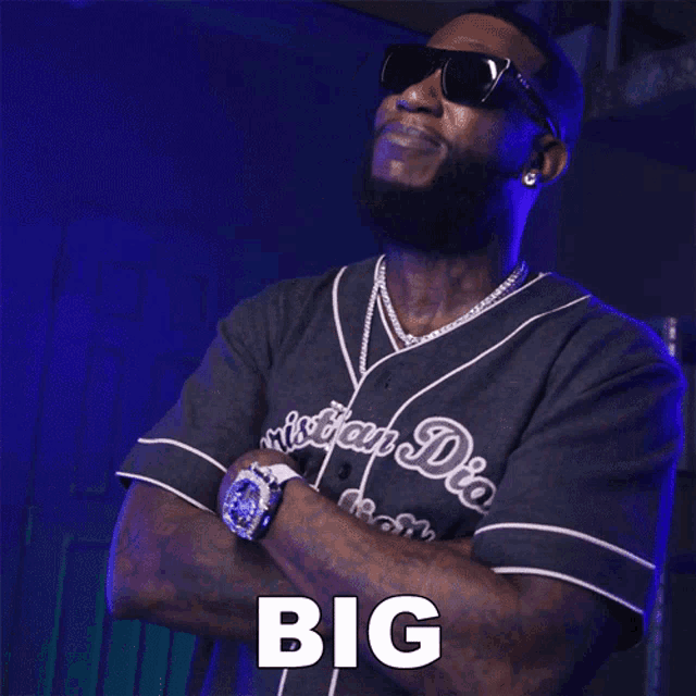 a man wearing sunglasses and a jersey that says big
