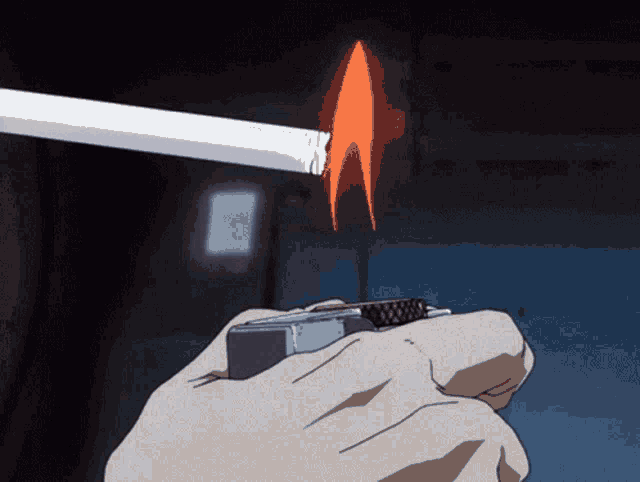 a person lighting a cigarette with a lighter in their hand