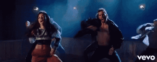 a man and a woman are dancing in a room in a vevo video .