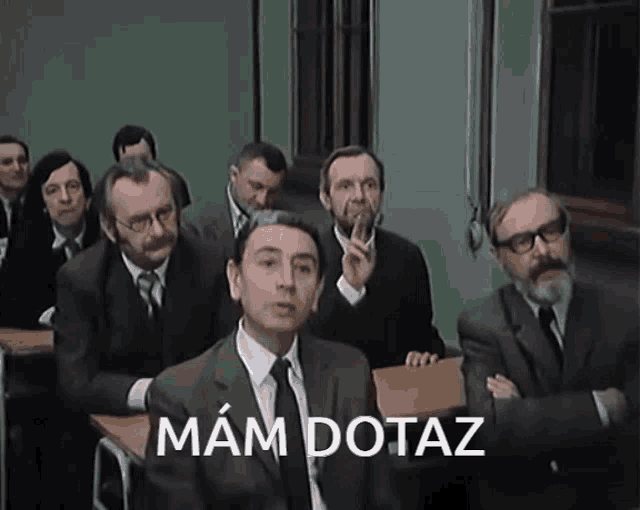 a group of men in suits and ties are sitting in a classroom with the words " mam dotaz " on the bottom