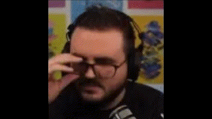 a man with a beard is wearing headphones and a microphone .