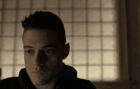 a close up of a man 's face in front of a window with squares