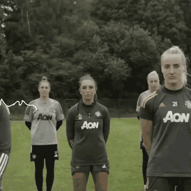 a group of female soccer players wearing acn shirts