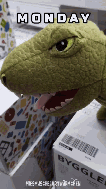 a picture of a stuffed dinosaur with monday written above it