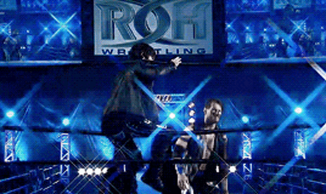 two men in a wrestling ring with a sign that says ' roh wrestling '