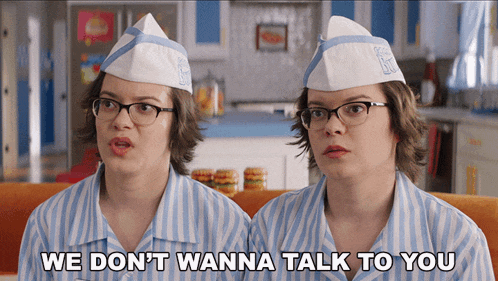 two women sitting next to each other with the words we do n't wanna talk to you on the bottom