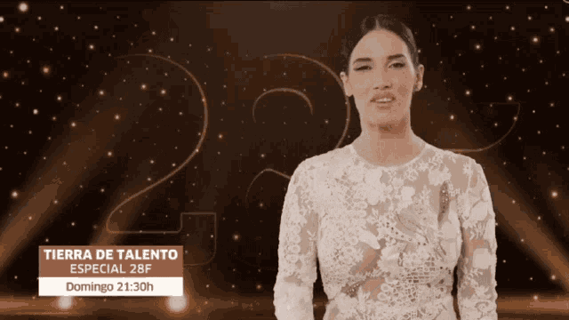 a woman in a white dress is standing in front of a sign that says tierra de talento
