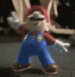 a blurred image of a mario figurine waving