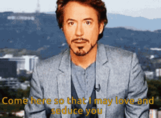 a man in a suit says " come here so that i may love and seduce you " in front of a hollywood sign