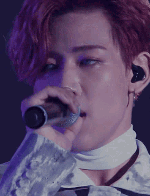 a close up of a person holding a microphone