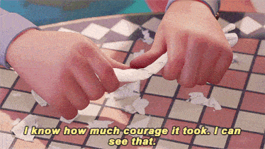 a person is holding a piece of paper and says " i know how much courage it took . i can see that "