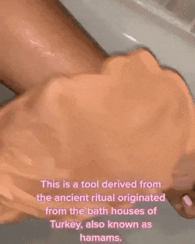 a person is applying lotion to their arm .