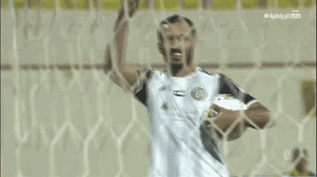 a soccer player wearing a jersey that says adidas on it